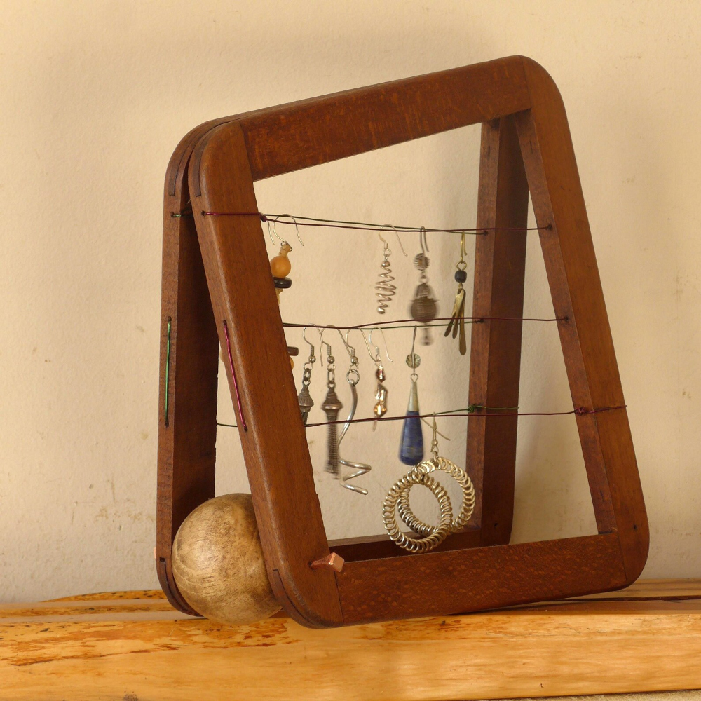 Quirky repurposed vintage tennis racket press frame used as jewellery holder